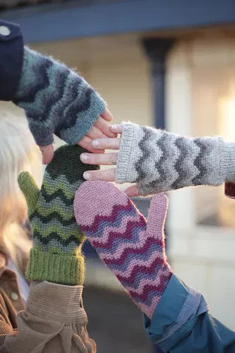 Four hands in circle with handknitted mittens on