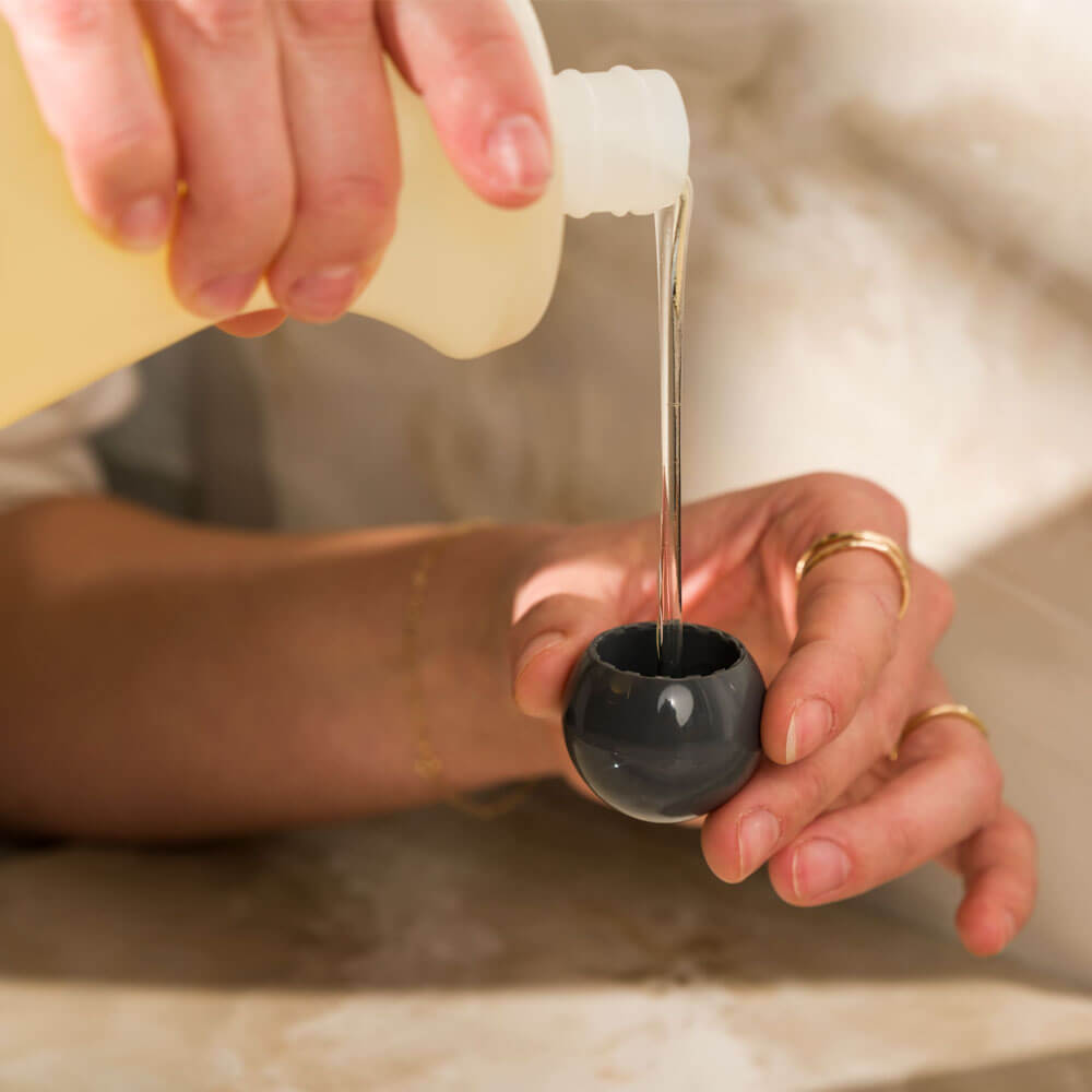 Eucalan Unscented Wool Wash 100 ml, pouring a capful